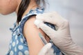 Doctor injecting vaccination in arm of asian little child girl