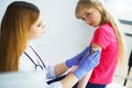 Doctor injecting vaccination in arm little child girl,healthy an Royalty Free Stock Photo