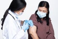 Doctor injects Covid-19 Vaccine to arm of Elderly Asian Woman