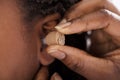 Doctor Inserting Hearing Aid