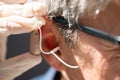 Doctor Inserting Hearing Aid Royalty Free Stock Photo