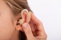 Doctor Inserting Hearing Aid In Girl`s Ear Royalty Free Stock Photo