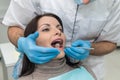 Doctor inspecting patient`s teeth with mirror close up