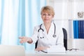 Doctor inviting patient on a chair Royalty Free Stock Photo