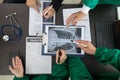 doctor joins a meeting with the surgeon's team to discuss a plan for cancer surgery after the medical team detects cancer.