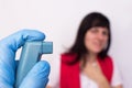 Doctor keeps asthma inhaler with salbutamol, in the background is a girl who is suffocating asthma, bronchodilator medications,