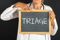Doctor keeps a blackboard with the text "Triage"