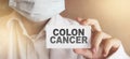 Doctor keeps a card with the name of the diagnosis - colon cancer. Selective focus. Medical concept Royalty Free Stock Photo