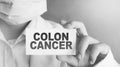 Doctor keeps a card with the name of the diagnosis - colon cancer. Selective focus. Medical concept Royalty Free Stock Photo