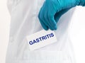 Doctor keeps a card with the name of the diagnosis - gastritis. Selective focus