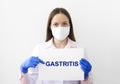 Doctor keeps a card with the name of the diagnosis - gastritis. Selective focus