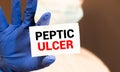 Doctor keeps a card with the name of the diagnosis peptic ulcer. Selective focus