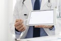 Doctor in labcoat showing digital tablet at hospital