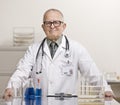Doctor in laboratory with beaker and vials