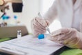 Doctor in the laboratory with a biological tube for analysis and sampling of Covid-19 infectious