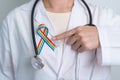 Doctor with LGBTQ Rainbow ribbon for Support Lesbian, Gay, Bisexual, Transgender and Queer community and happy Pride month concept