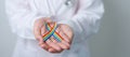 Doctor with LGBTQ Rainbow ribbon for Support Lesbian, Gay, Bisexual, Transgender and Queer community and happy Pride month concept
