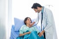 The doctor listened to the female patient heartbeat on the bed in the hospital room Royalty Free Stock Photo