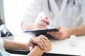 Doctor listening patient explain his symptom and notes to medical record Royalty Free Stock Photo