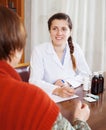 Doctor listening patient at table Royalty Free Stock Photo