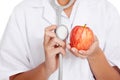 Doctor listening to an apple with a stethoscope Royalty Free Stock Photo