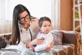 The doctor listens to the babys breath. medicine, healthcare and pediatrics concept - close up of female doctor with stethoscope