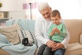 Doctor and little patient with digital glucose meter at home Royalty Free Stock Photo