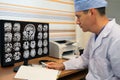 Doctor looking at MRI scan of skull on monitor Royalty Free Stock Photo
