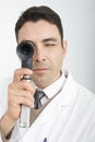 Doctor Looking Through Ophthalmoscope Royalty Free Stock Photo