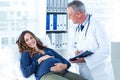 Doctor looking at pregnant woman in clinic Royalty Free Stock Photo