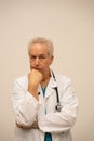 Doctor looking puzzled at camera with hand under chin