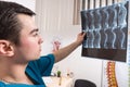 Doctor looking at X-ray image showing spine Royalty Free Stock Photo