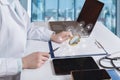 Doctor looks at the document through a magnifying glass