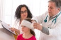 Doctor makes a bandage to little girl head