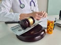 Doctor makes notes in medical documents in clinic on court gavel table concept Royalty Free Stock Photo