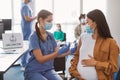 Doctor Making Coronavirus Vaccine Injection To Pregnant Asian Lady Royalty Free Stock Photo