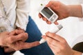 Doctor making diabetes blood test on senior woman, closeup Royalty Free Stock Photo