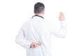 Doctor making false oath with crossed fingers behind back