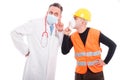 Doctor making listening gesture and constructor showing sush Royalty Free Stock Photo