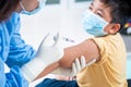 Doctor making a vaccination in the shoulder of patient boy or child person and happy, Injection on Arm, coronavirus,covid-19