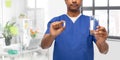 doctor or male nurse with medicine pill and water Royalty Free Stock Photo