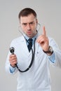 Doctor male pointing finger up with stethoscope Royalty Free Stock Photo