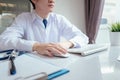 Doctor male working with computer on desk clinic health care for patient technology help support Royalty Free Stock Photo