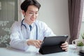 Doctor male working with tablet on desk clinic health care for pateint technology help support Royalty Free Stock Photo