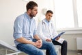 Doctor and man with health problem at hospital Royalty Free Stock Photo