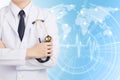 Doctor man posting and holding stethoscope on global network background. Royalty Free Stock Photo