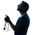 Doctor man praying silhouette portrait Royalty Free Stock Photo