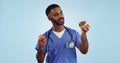 Doctor, man and studio for donut, apple and choice with thinking for healthcare by blue background. Medic, person or Royalty Free Stock Photo