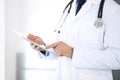 Doctor man using tablet computer for network research or virtual disease treatment, hands close-up. Perfect medical Royalty Free Stock Photo