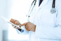 Doctor man using tablet computer for network research or virtual disease treatment, hands close-up. Perfect medical Royalty Free Stock Photo